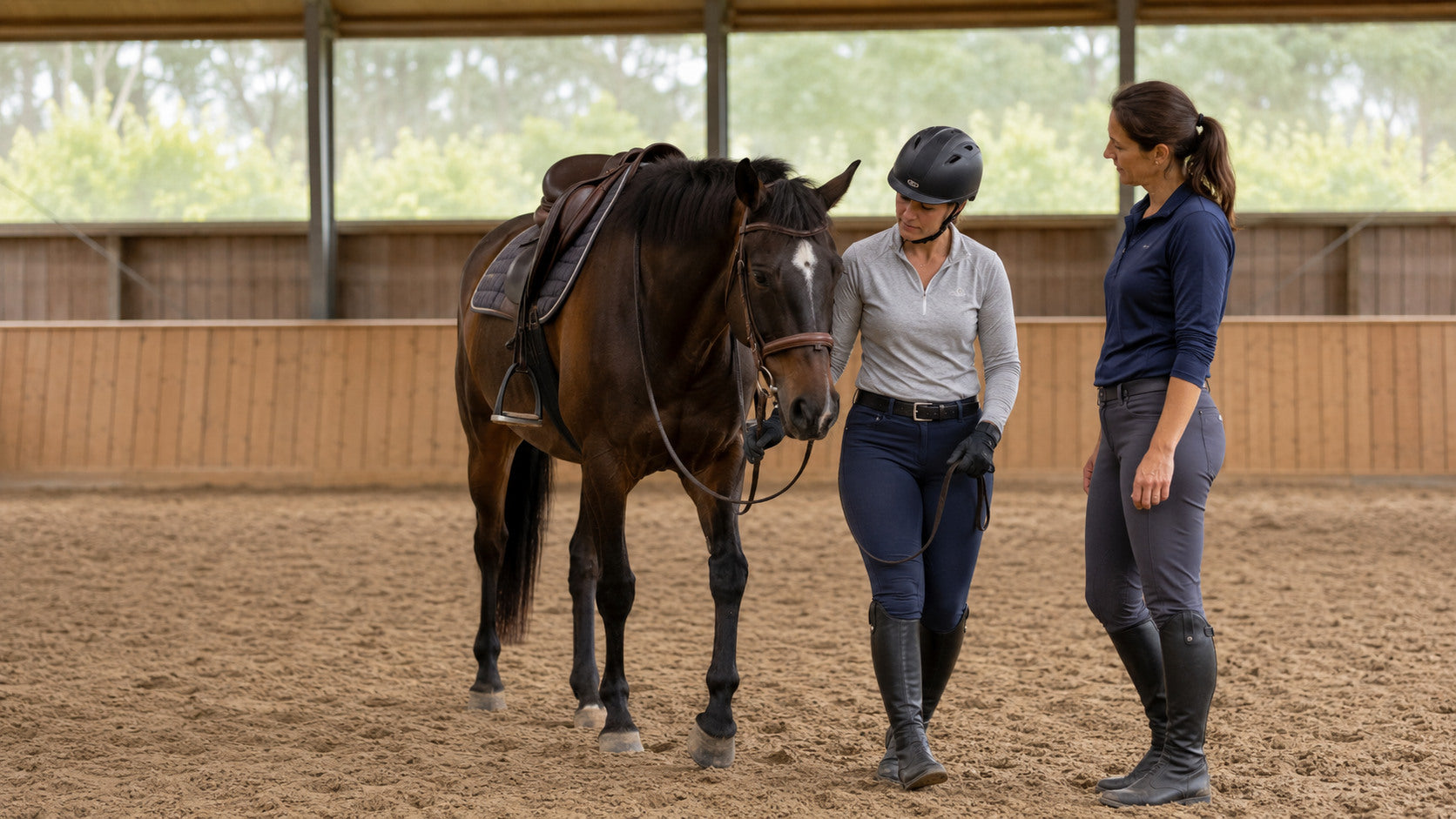 Helmeted rider rebuilding confidence with an instructor beside a quiet horse