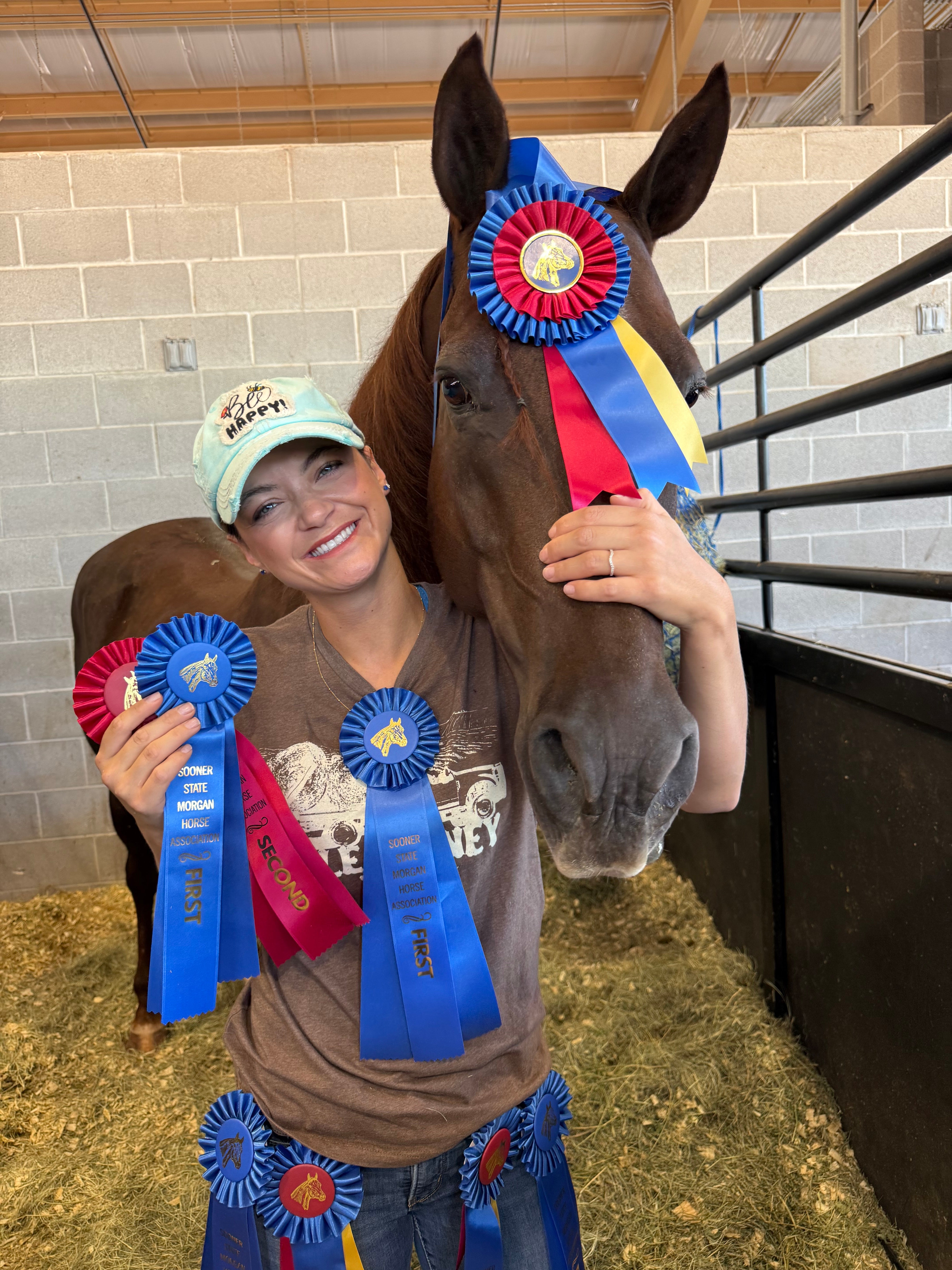 Anna Ryen Rowe with her horse and award ribbons, Draw It Out Real Rider of the Month