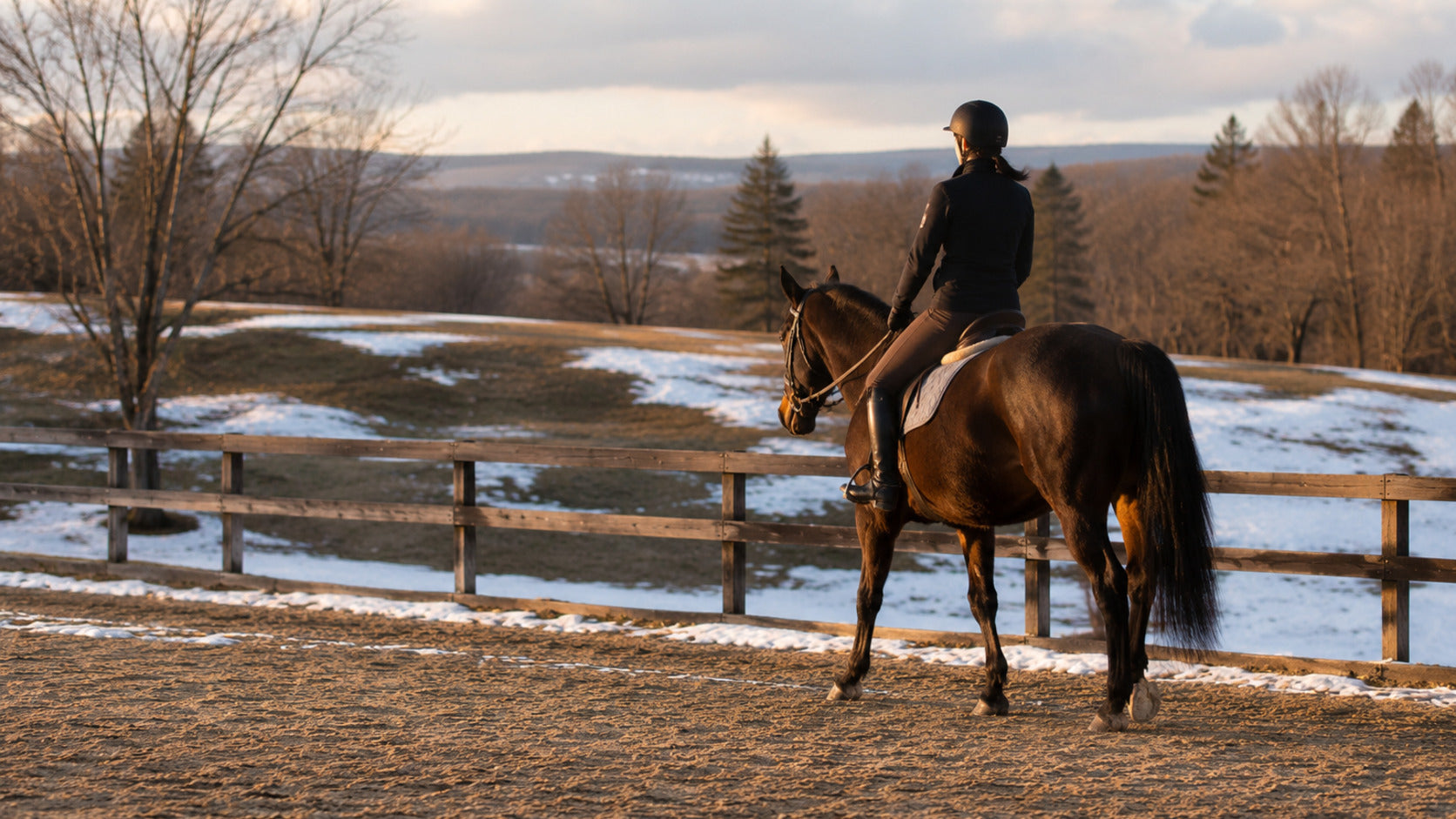 Horse and rider walking on safe footing during a deceptive late-winter warm day