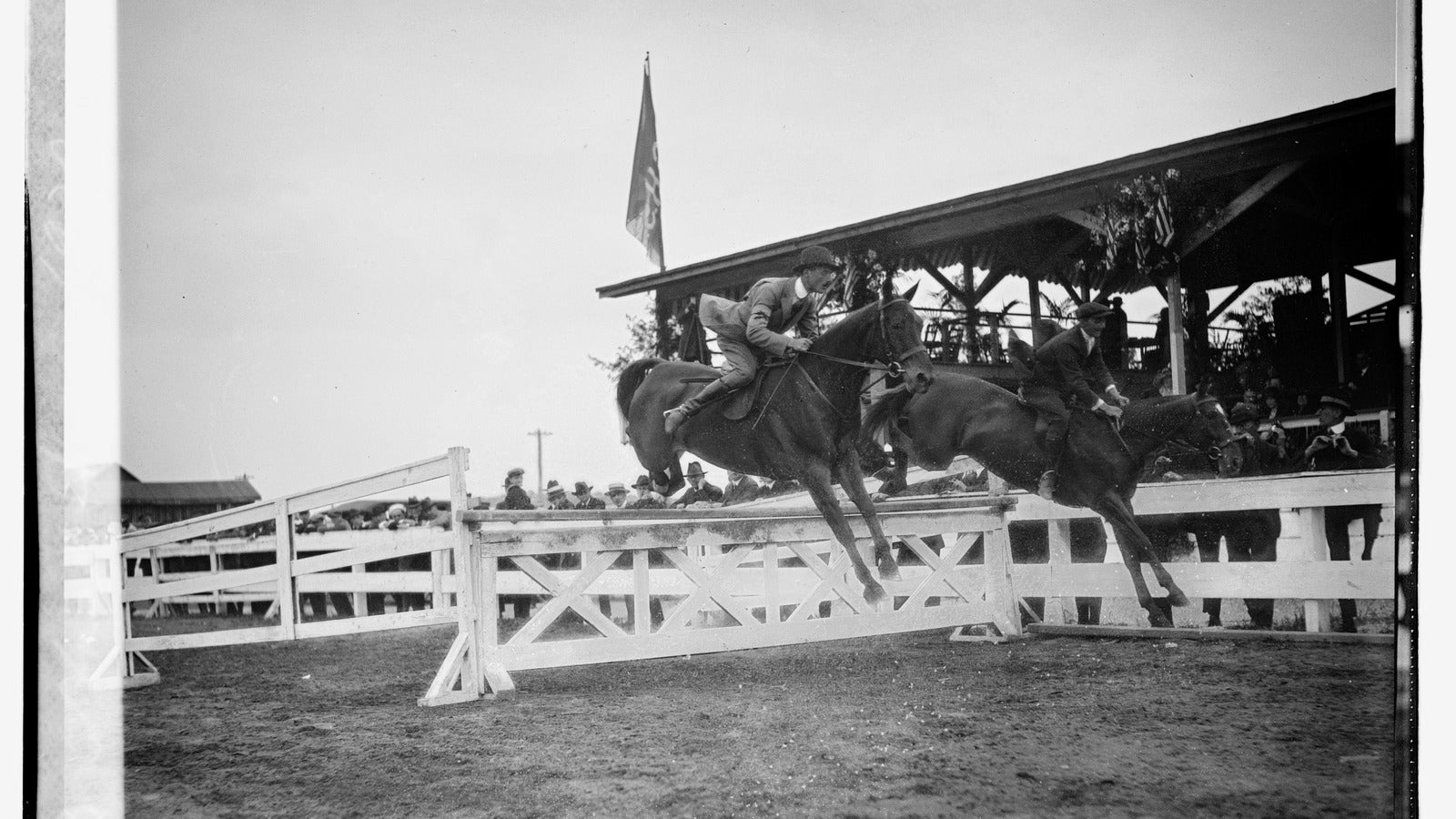 Two riders jumping horses during a multi-day horse show