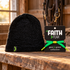 Black Faith > Fear knit beanie and Hope Green LaceBand bracelet together on a wooden tack-room bench