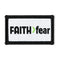 Faith > Fear adhesive hat patch with a black border, white woven face and green greater-than symbol